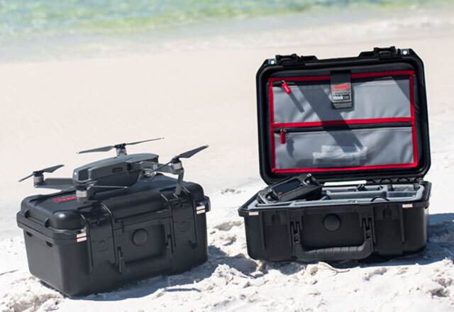 Custom hard case for a drone sitting on a beach.